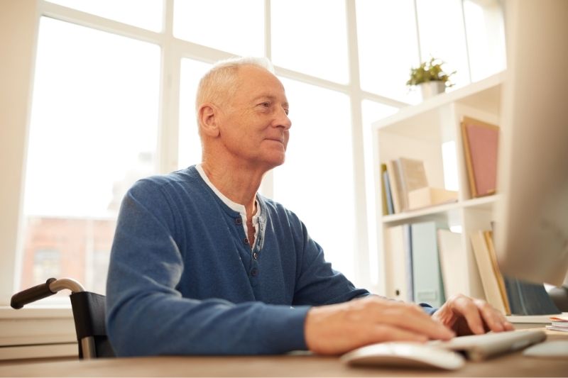 Person in wheelchair looking at computer