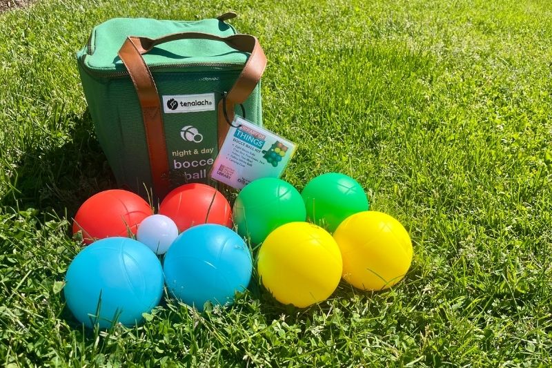 A bocce ball set sitting on grass.